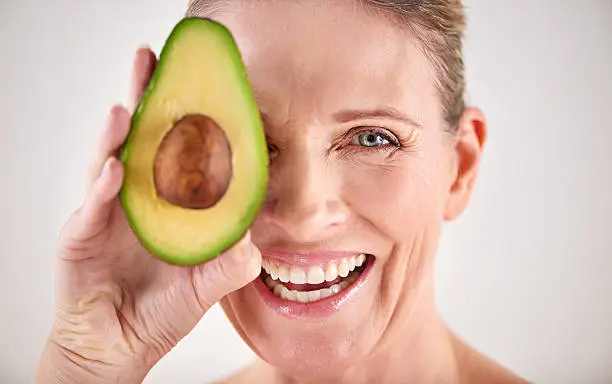 Cropped studio portrait of a mature woman holding up an avocadohttp://195.154.178.81/DATA/i_collage/pi/shoots/784083.jpg