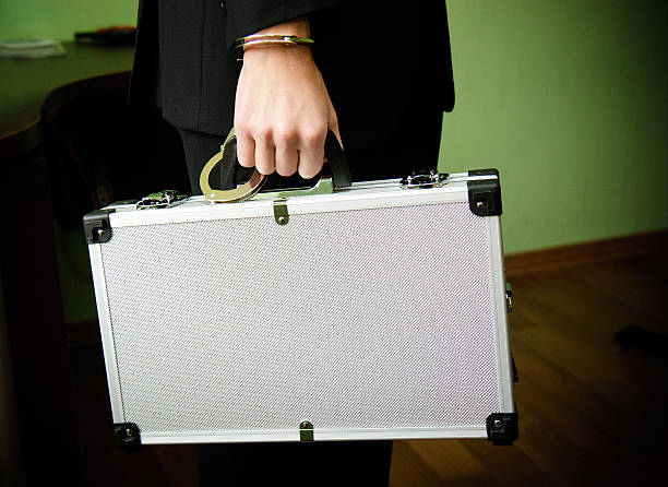 istock Hand in handcuffs holding money suitcase 491715066