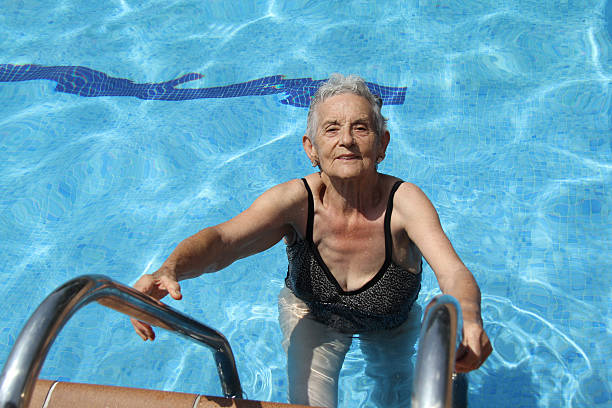 istock Senior Woman Having Fun In Swimming Pool 491715078