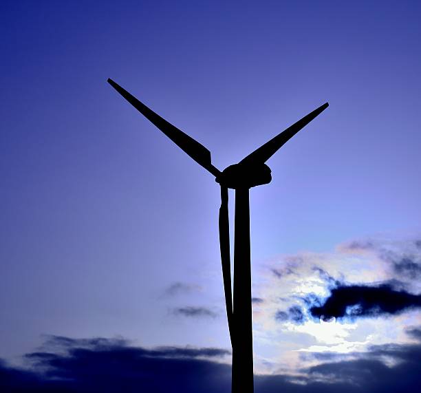 istock Wind turbine at sunrise with color effects 491725274