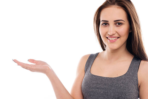 istock Smiling Woman Showing open hand 491725336