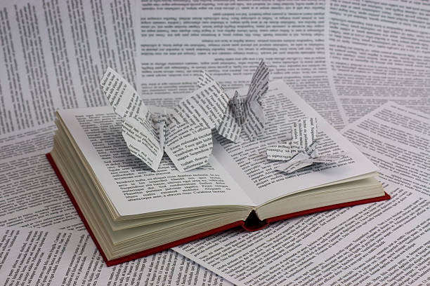 Origami butterflies coming out of a book stock photo
