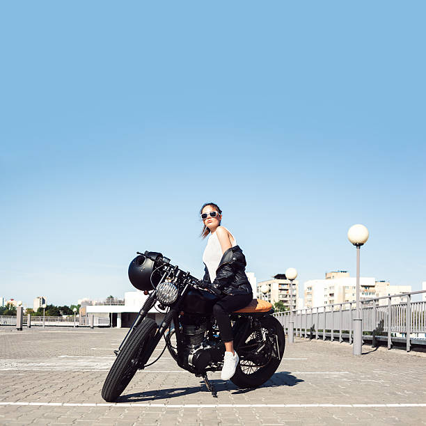 istock Biker girl sitting on vintage custom motorcycle 491726574