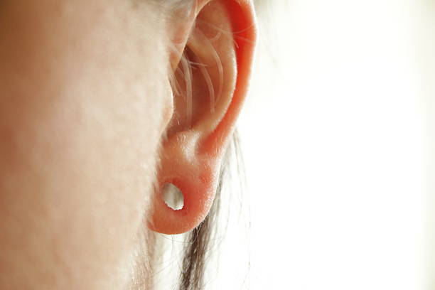 ear hole close up of an ear hole Earlobe stock pictures, royalty-free photos & images