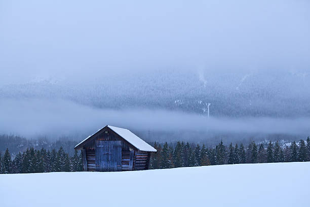 istock old wooden hut on snow in Alps 491726710