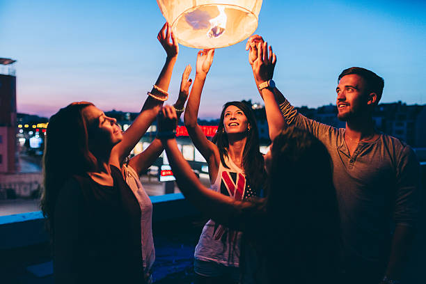 istock Friends releasing paper lantern 491726946