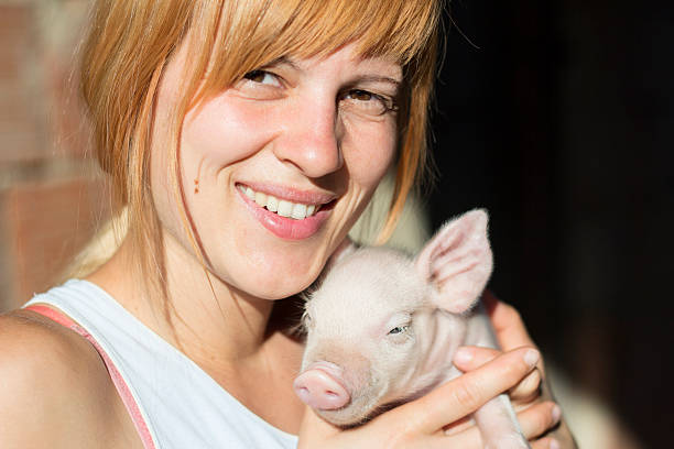 istock Girl and piglet 491728792