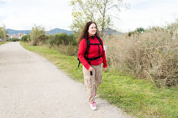 woman hiker hiking in forest walking on the trail