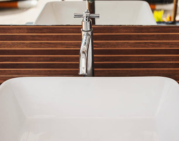 istock Wasting water, Water tap on wooden background 491730656