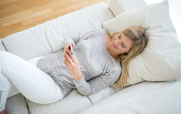istock Woman at home texting on her phone 491730818