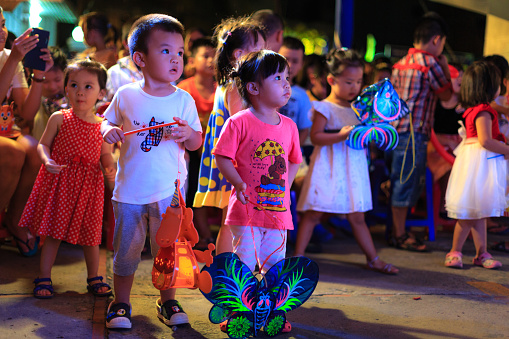 Hochiminh City, Vietnam - September 26, 2015: Children are happy to attend mid-autumn festival at a residential building in the city of HoChiMinh. Mid-Autumn Festival is a celebration of the full moon in August every year in Vietnam
