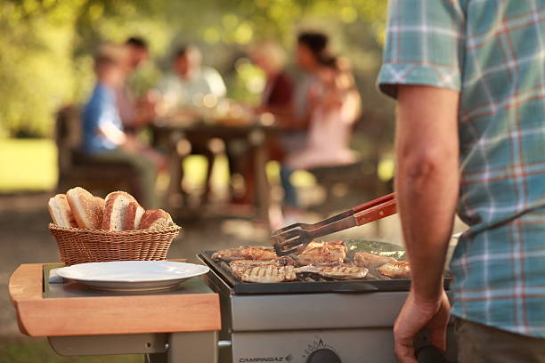 istock Man grilling meat on barbecue grill 491731834