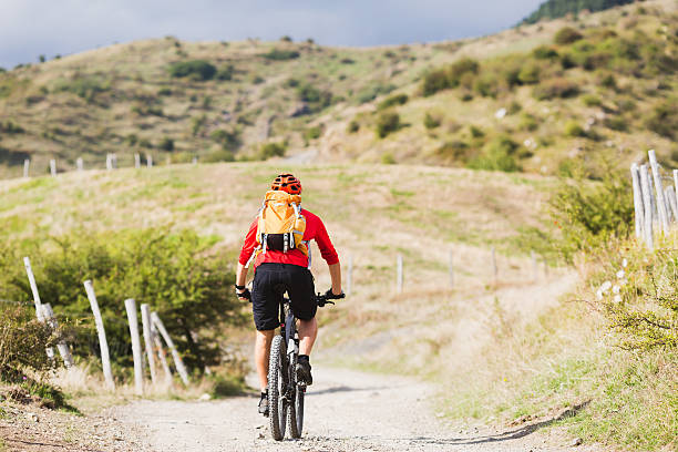 istock Man enduro mountain biking on country road 491732144