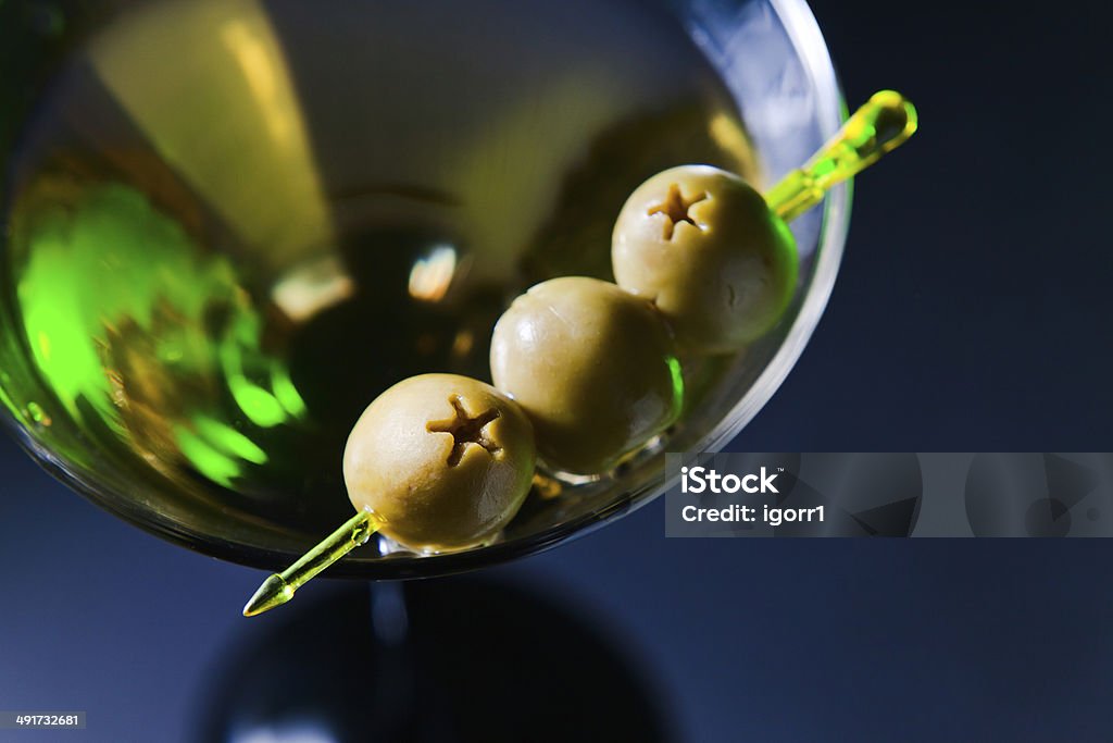 martini with green olives martini with green olives , focus on oliwes Alcohol - Drink Stock Photo