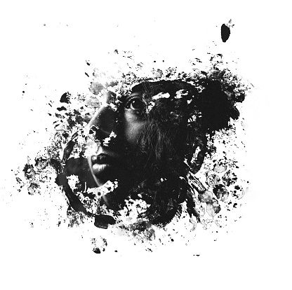 Monochrome image of a graphic splatter shape with a woman's face within it using a double exposure photographic effect