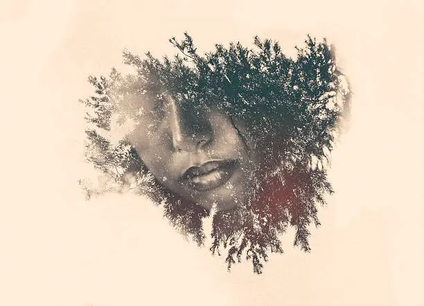 Photo of Double exposure of a woman's mouth within foliage