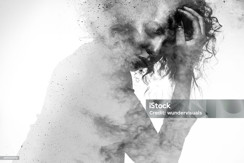 Unhappy woman's form double exposed with paint splatter effect Subtle woman's form in an unhappy pose double exposed with a monochromatic paint splatter photographic effect Women Stock Photo
