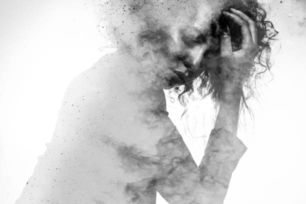 Unhappy woman's form double exposed with paint splatter effect Subtle woman's form in an unhappy pose double exposed with a monochromatic paint splatter photographic effect woman emotion stock pictures, royalty-free photos & images