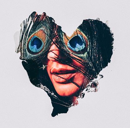 Abstract image of a heart shape with a woman's face framed within it with peacock feathers mysteriously covering her eyes