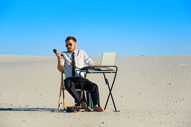 istock Businessman using  laptop in a desert 491760984