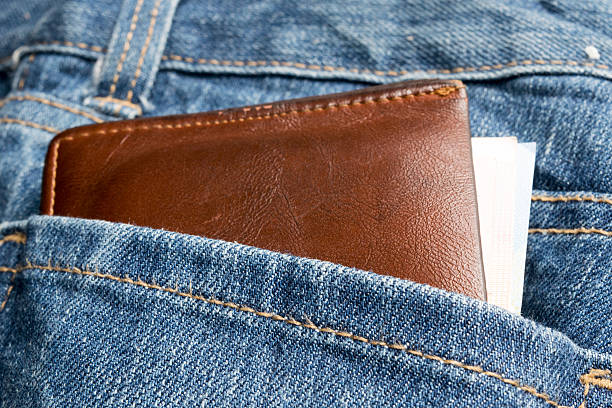istock Leather wallet and money  on jean background 491762056