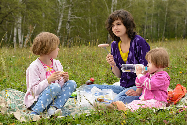 istock Mother with two daughters on a picnic 491764002