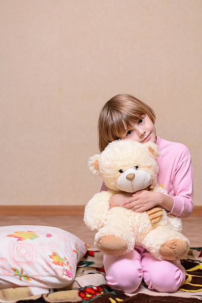 istock Girl sitting on the bed next to pillow 491765136