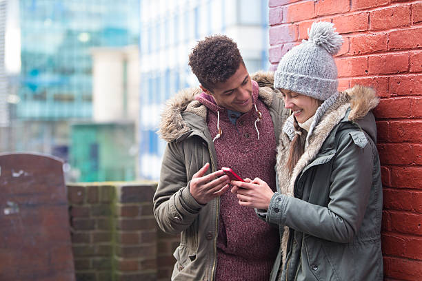 istock Young couple looking at a smartphone together 491765314