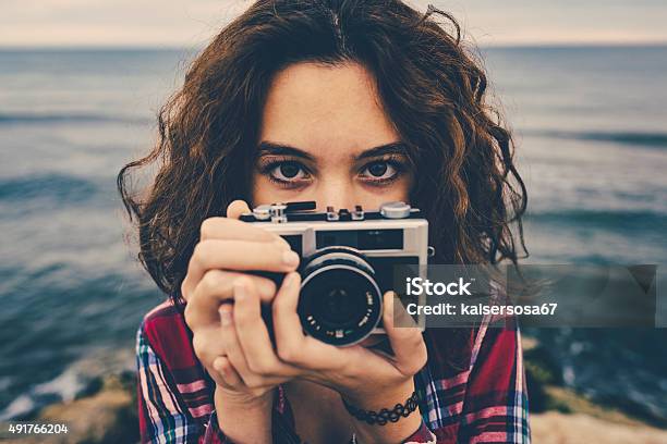 Girl Taking A Photo At Sea With A Film Camera Stock Photo - Download Image Now - Retro Style, Camera - Photographic Equipment, Nature