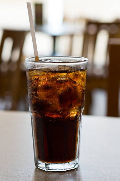 istock glass of cola with ice on a table 491766868