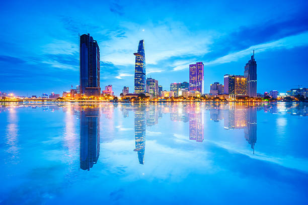 Reflection of Nightview of Business and Administrative Center of Saigon Reflection of Night view of Business District and Administrative Center of Ho Chi Minh city on Saigon riverbank. Ho Chi Minh city (aka Saigon) is the biggest city and economic center in Vietnam with population around 10 million people. It is also a popular tourist destination of Asia. ho chi minh city stock pictures, royalty-free photos & images