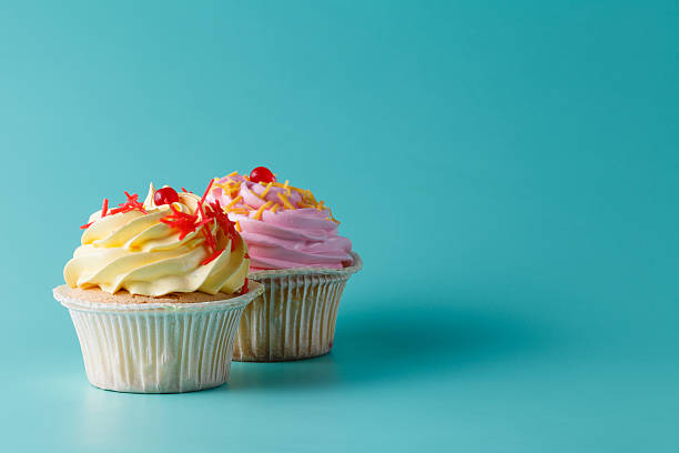 istock colorful pink cupcake on aquamarine background 491777192