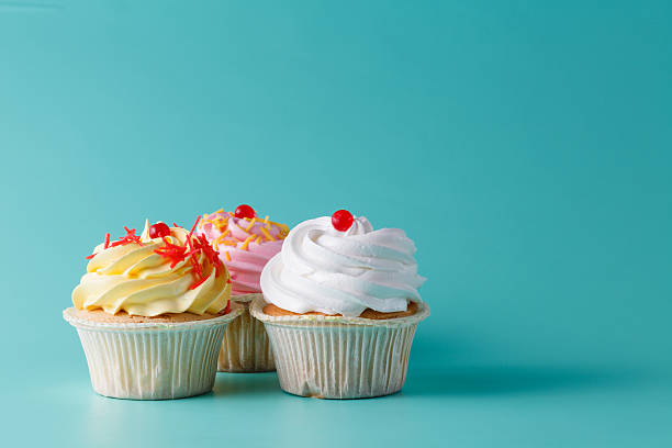istock colorful pink cupcake on aquamarine background 491777220