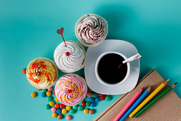istock Cupcakes with colorful confetti and coffee cup 491777548