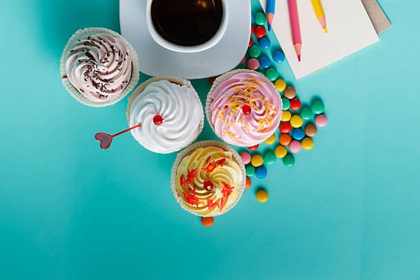 istock Cupcakes with colorful confetti and coffee cup 491777562