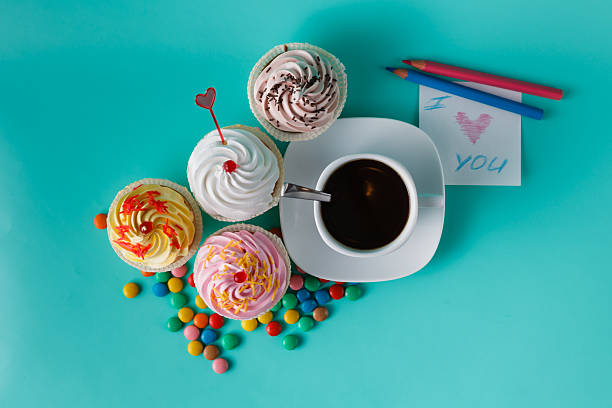 istock Cupcakes with colorful confetti and coffee cup 491777620