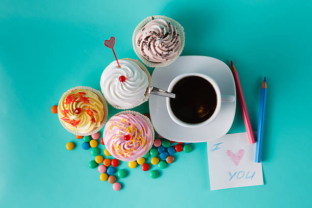istock Cupcakes with colorful confetti and coffee cup 491777648
