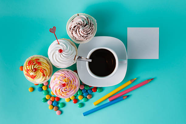 istock Cupcakes with colorful confetti and coffee cup 491777674