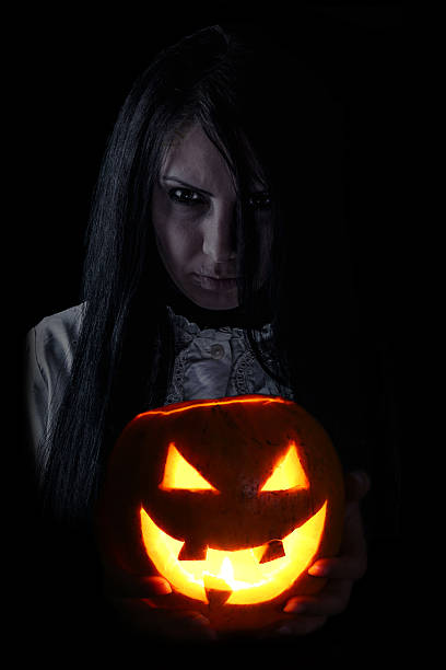 恐ろしい girl holding ジャック o ランタン - witch smiling evil bizarre ストックフォトと画像