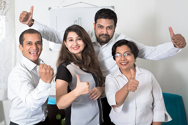 Group of cheerful Business people showing thums up sign stock photo