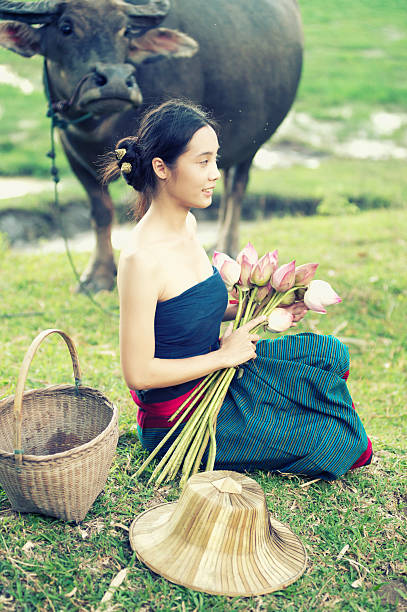 istock thai ancient young women with buffalo on rural 491780282