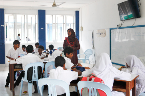Huraa Island, Maldives - April 30, 2014: Teacher with young pupils having an class in the local primary school.