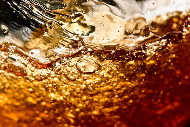 detail of an alcoholic beverage detail of an alcoholic beverage on black background whiskey photos stock pictures, royalty-free photos & images
