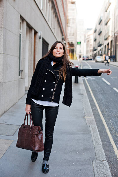 istock GIRL CATHING A TAXI 491783959