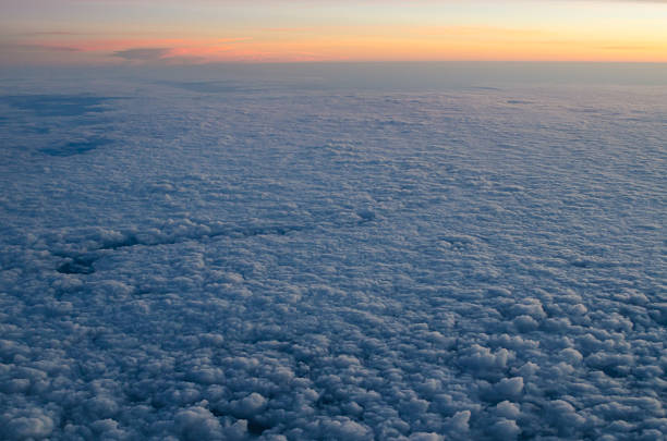 Bed of clouds from above at dawn stock photo