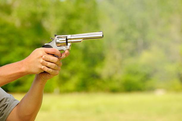 istock Shooting silver revolver gun with smoke 491785909
