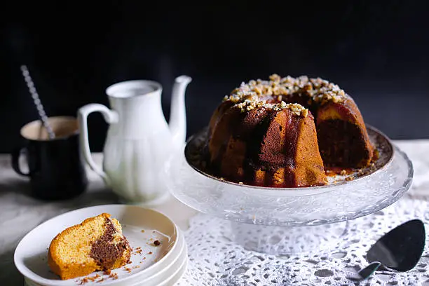 Gugelhupf bundt marble cake with caramel and nuts served with hot white chocolate drink, winter, traditional cake
