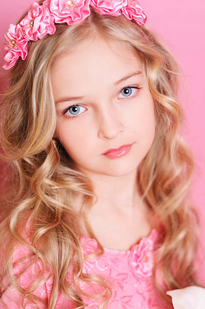 istock Beautiful kid girl posing over pink 491786481