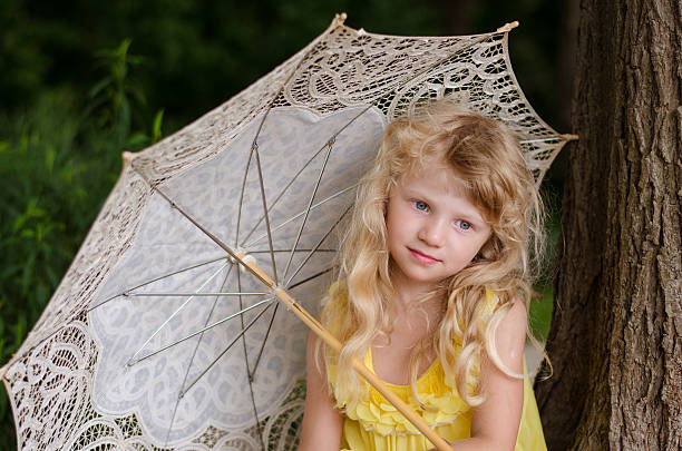 istock little girl holding sunshade 491786788