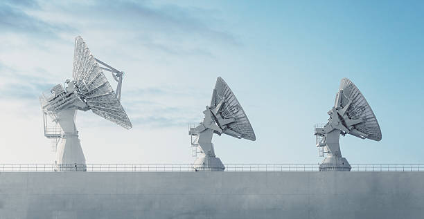 Trio of Satellite Dishes Three satellite dishes perched high atop the deck of a vessel used in tracking rocket trajectories.  Long exposure in twilight. satellite dish photos stock pictures, royalty-free photos & images